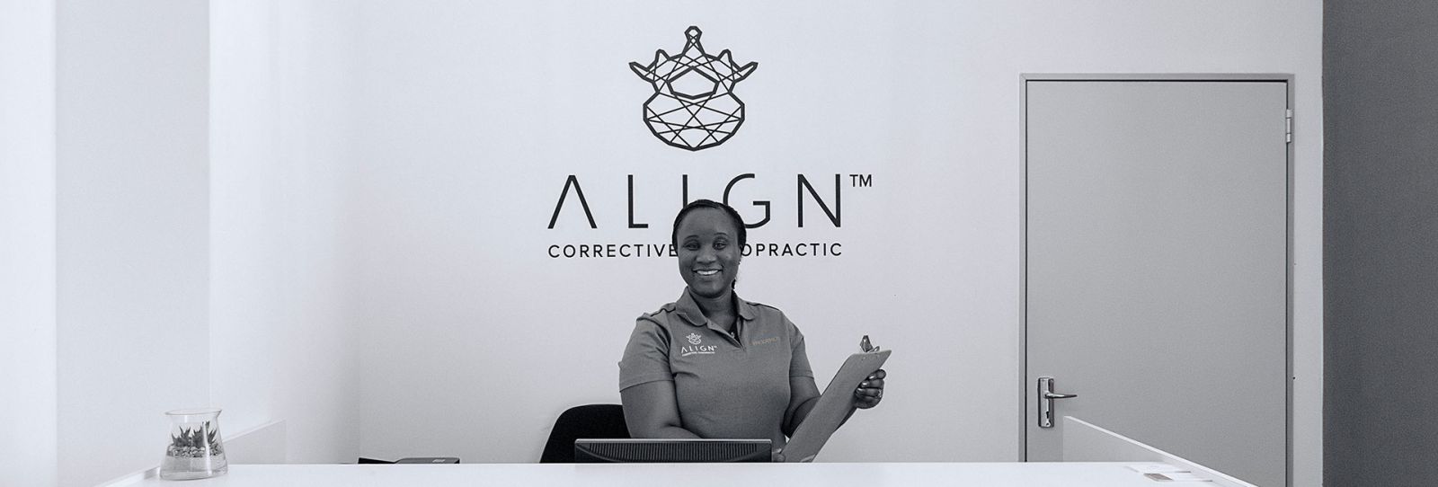 Smiling receptionist at the Align Corrective Chiropractic front desk