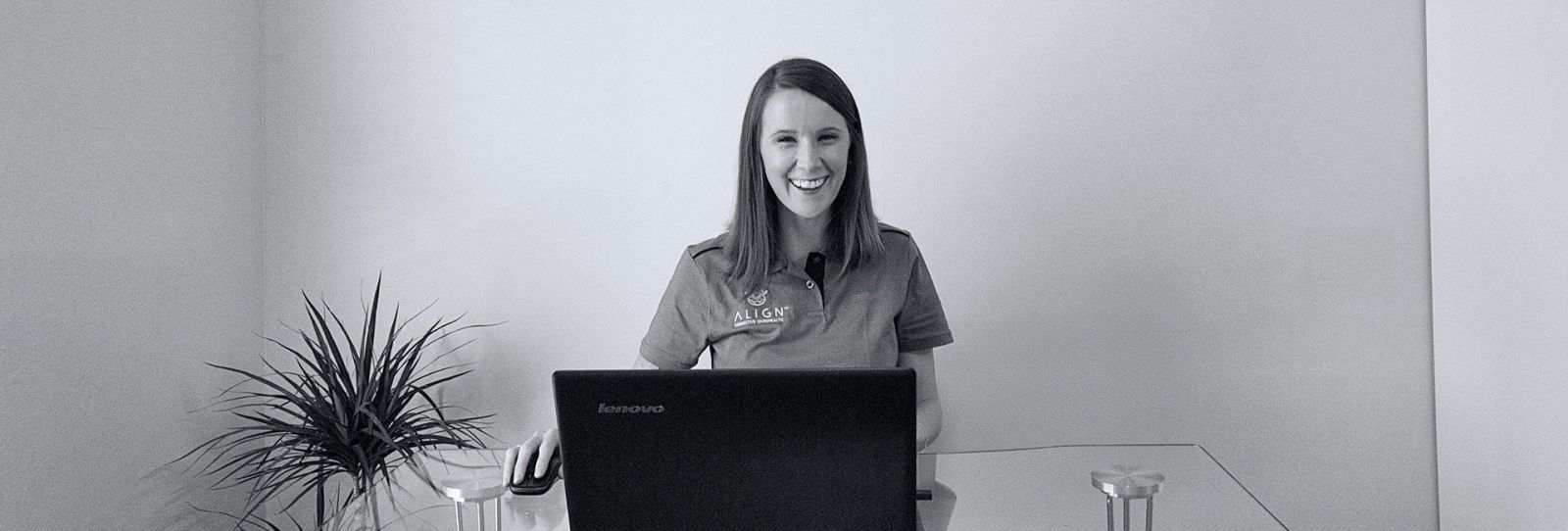 Leigh, practice manager, welcoming patients at the Align Corrective Chiropractic reception desk